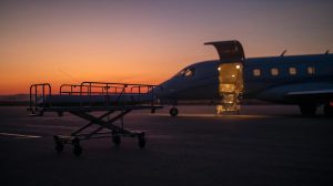 “Medical evacuation jet on runway at sunset with stretcher ready, symbolizing urgent transport and global emergency support.”
